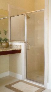 a frameless hinged shower door in a bathroom